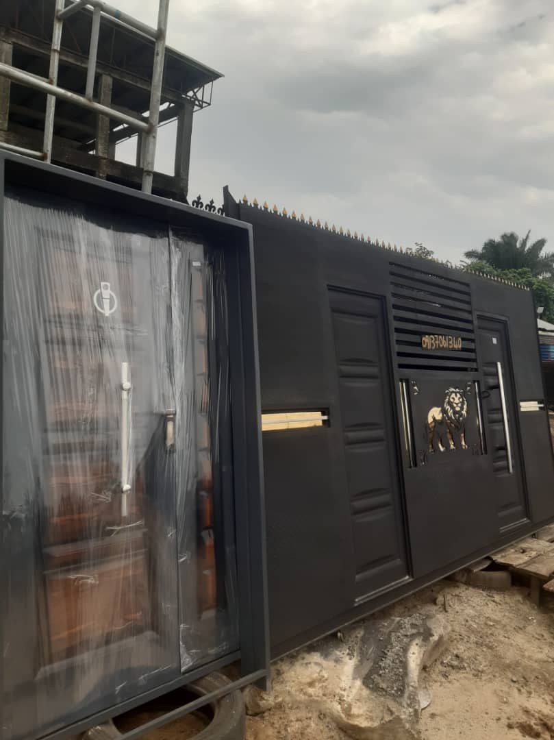 Custom black steel gate and perimeter wall with clean modern paneling.