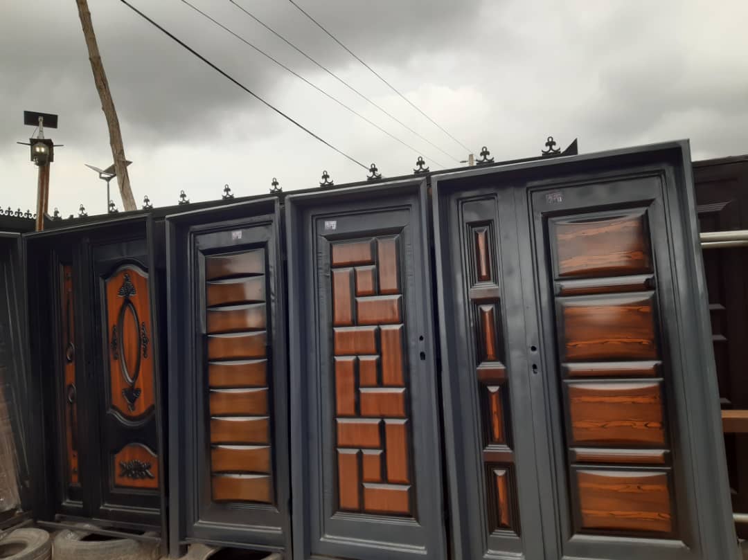 Row of custom steel doors finished with warm wood-grain panels.